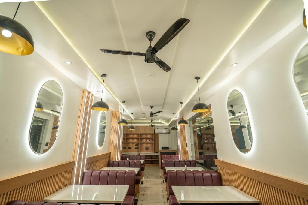 The actual dining area with burgundy booths at The Vaishvik