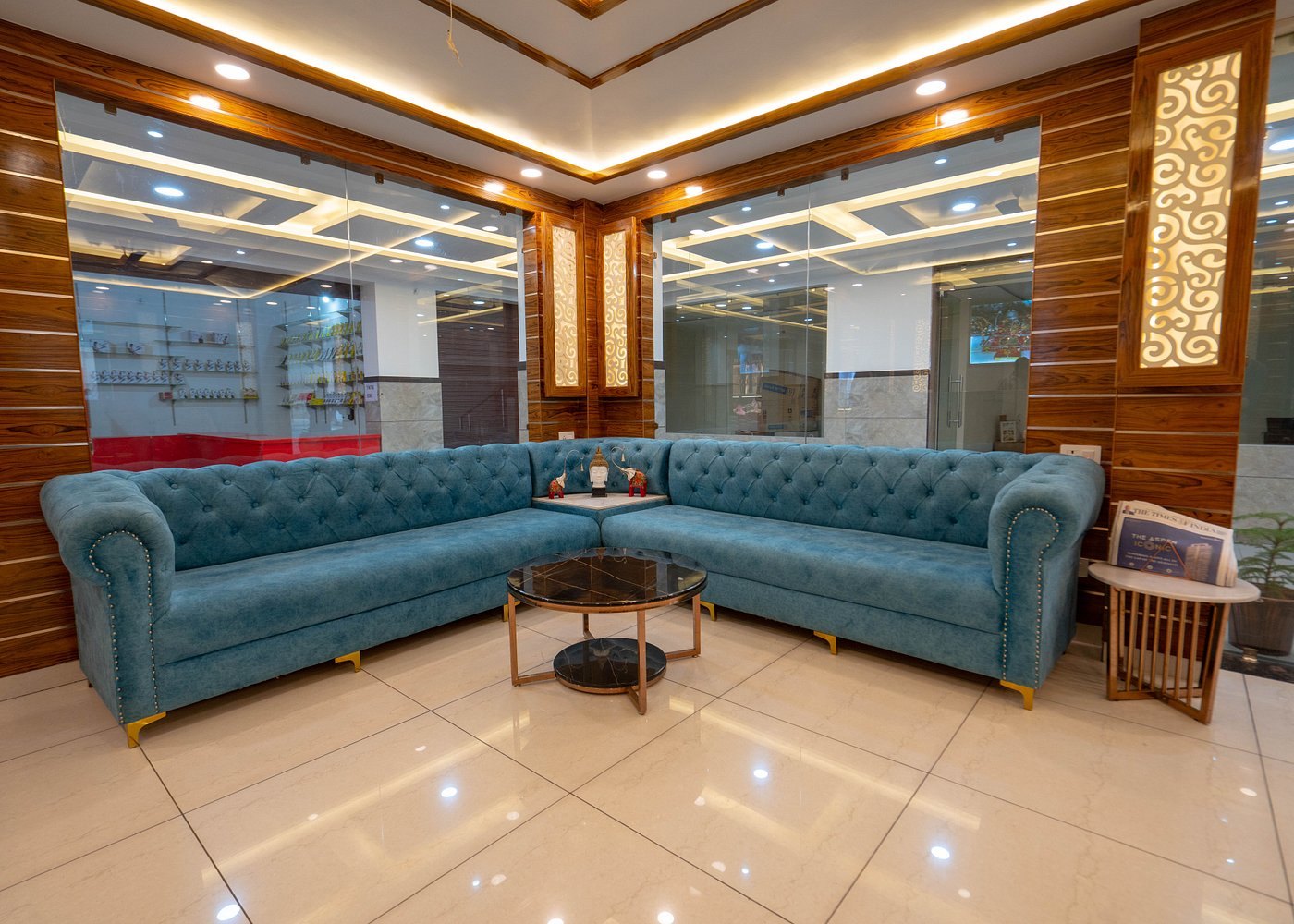 Turquoise seating and wood finishes in The Vaishvik lobby